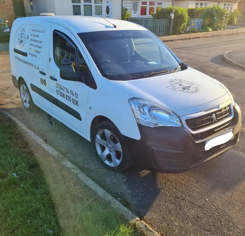 Alex Auto Locksmith’s white van seen from the front, with the phone number along its side